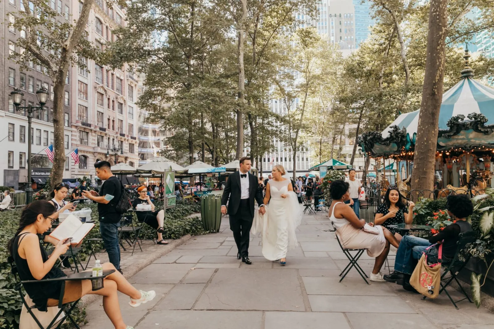 Bride and groom walking through a New York City plaza
