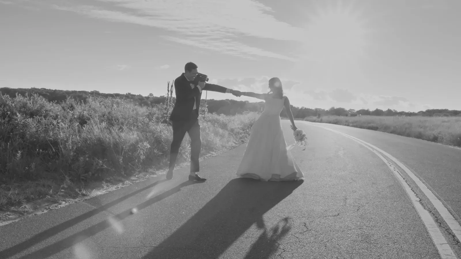 Julia and Ned on a coastal road, Shelter Island wedding at Ram's Head Inn
