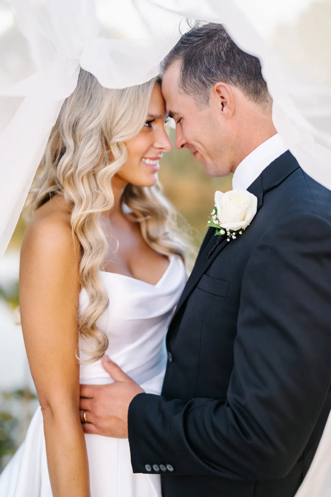 Bride and groom forehead to forehead beneath the veil, Long Island luxury wedding photography by Ashley Film Studios
